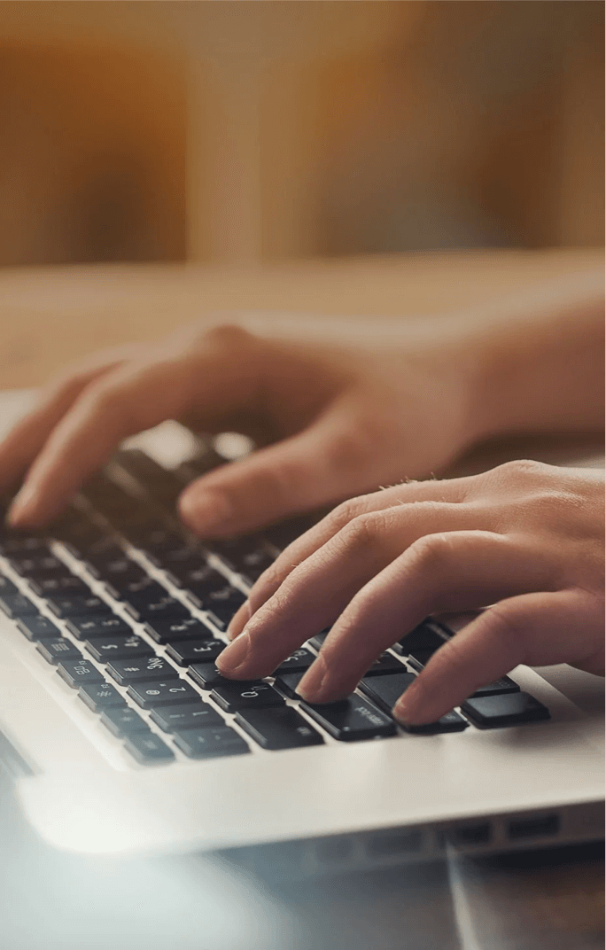 hands typing on computer keyboard